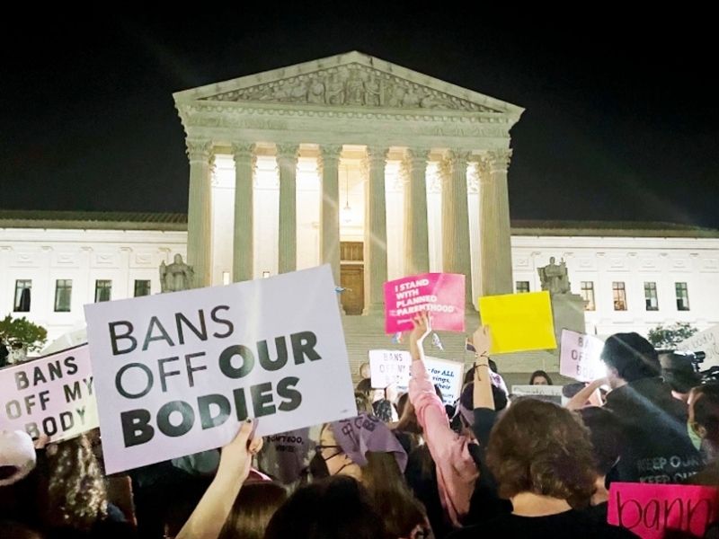 A crowd of people gather outside the Supreme Court after a majority Supreme Court opinion that would overturn Roe v Wade leaked