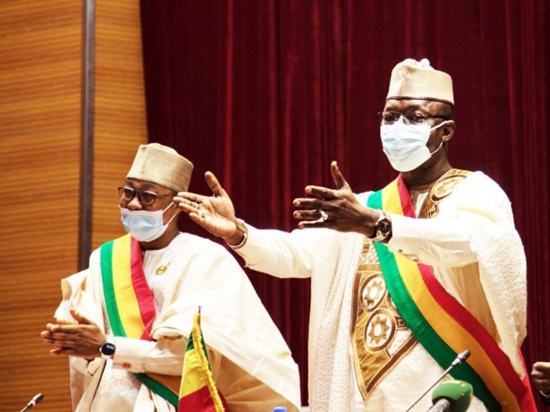 Malick Diaw, right, addresses members of the council during a meeting to vote on a revised charter in Bamako on February 21