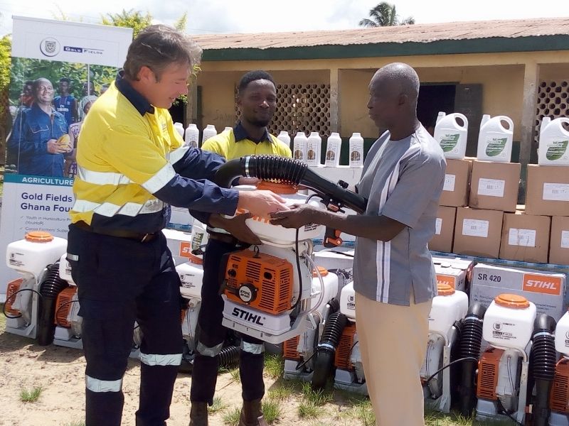 Michiel van der Merwe, Ag Vice President Operations handing over Mist blower to a beneficiary farmer