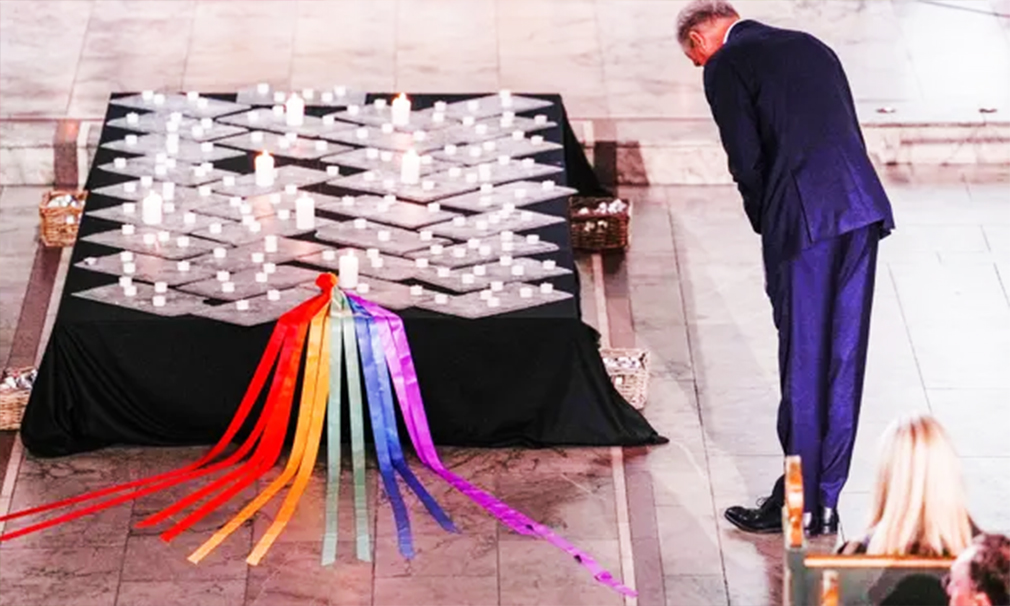 Norwegian prime minister, Jonas Gahr Støre, lights a candle at the memorial service at Oslo Cathedral