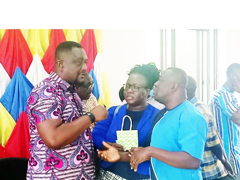 Samuel D.M Mahama, left, interacting with Sakyiwaa Mensah, the Tema Regional ECG PRO, middle, and another staff before the presser at the Krobo District of ECG, Somanya