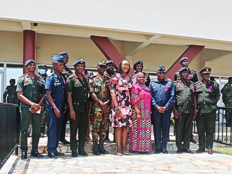 Photograph of breast cancer survival Hajiah Zainab Mahammed (in Africa print) with officers of the Ghana Armed Forces and the 37 Military Hospital