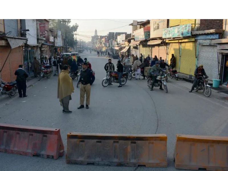 Security officials stand guard on a blocked road leading to the facility in Bannu in Pakistan's Khyber Pakhtunkhwa province