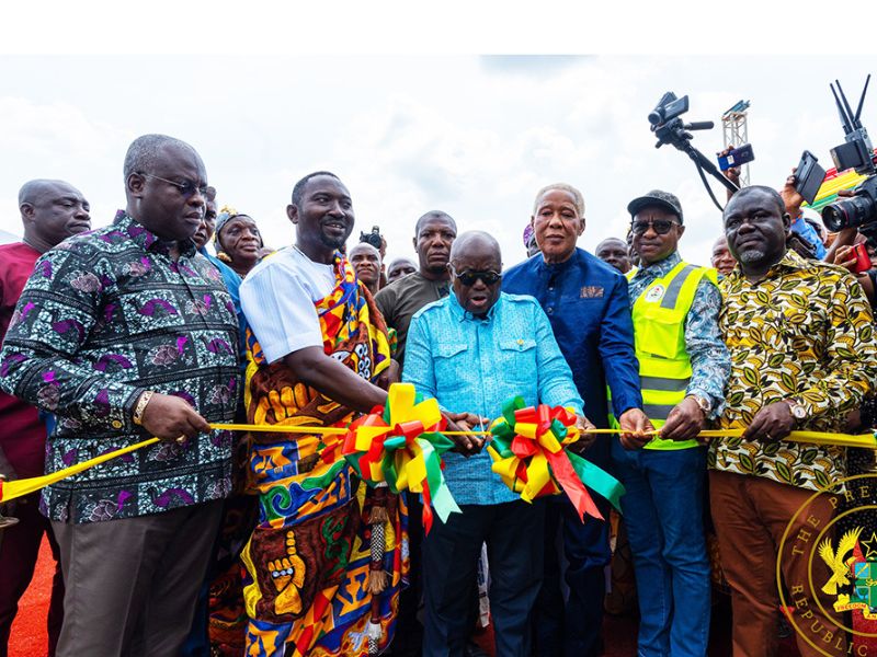 President Akufo-Addo cutting tape to commission the Afienya Road Over Bridge project. With him are some ministers, the MP, Prampram Chief, others