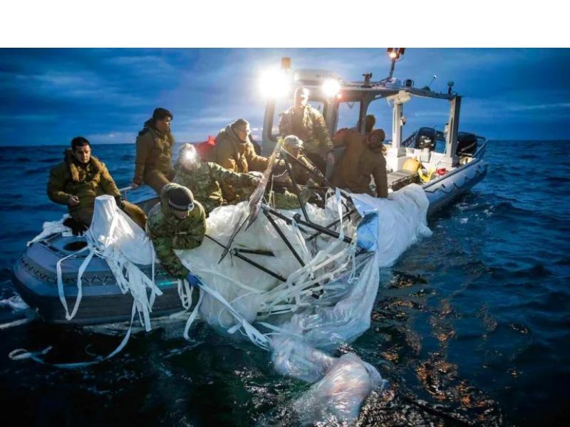 This image provided by the US Navy shows members recovering the balloon off the eastern coast of the US