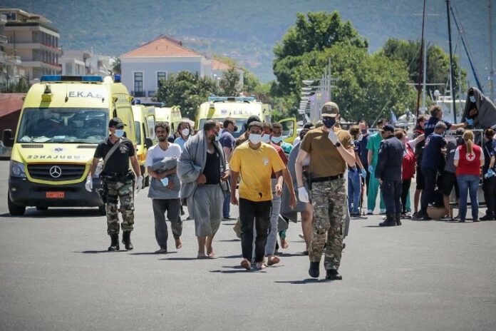 Refugees and migrants arrive at the port of Kalamata, following a rescue operation, after their boat capsized at open sea, in Kalamata, Greece