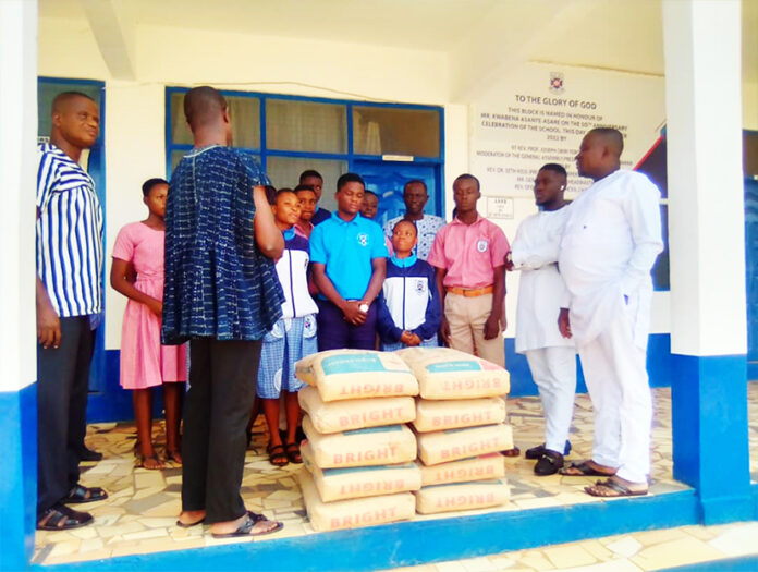 Mr Gabriel Keesi Yeboah (in white) donating some bags of cement to the Begoro Presbyterian Senior High School (SHS)