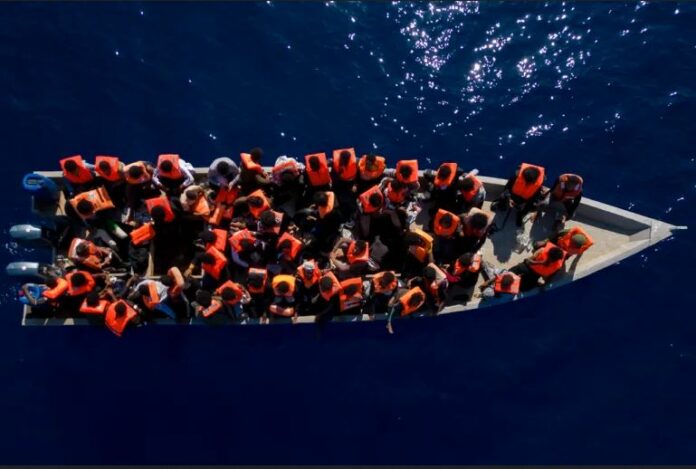 People from Eritrea, Libya and Sudan are packed on a wooden boat before being assisted by aid workers of the Spanish NGO Open Arms, in the Mediterranean Sea north of Libya, in June 2023
