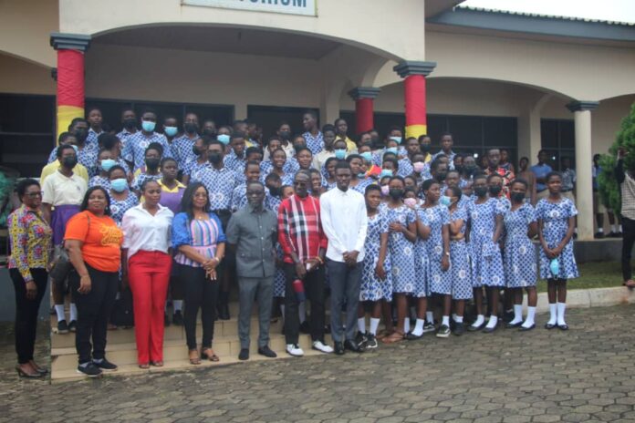 The Assembly member for Aburi West Electoral Area in Akuapem South municipality Hon.Daniel Asiamah 9in white long sleeve) with some of the personalities and students