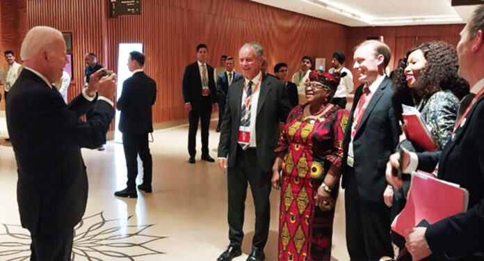 President Joe Biden is seen snapping photos of the Director-General of the World Trade Organisation (WTO), Ngozi Okonjo-Iweala