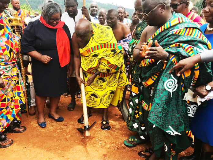 Osagyefo Amoatia Ofori Panin II breaking the ground for the commencement of the facility whilst others looks on with cheers.