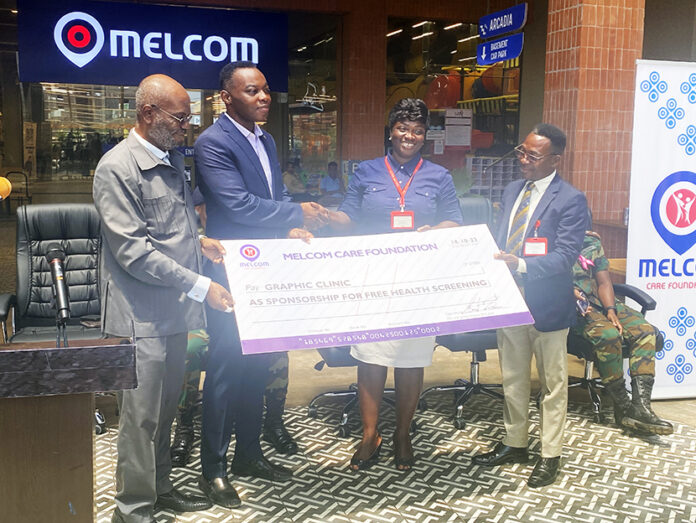 Melcom Group (last two left) donating dammy cheque to Graphic Groups of Communication (last two right)