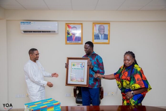 Minister for Education, Dr Osei Yaw Adutwum about to hand over a citation to the departing UNESCO boss