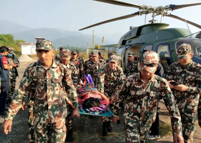 Army personnel carry an injured person on a stretcher after an earthquake in Jajarkot, Nepal, on November 4, 2023.