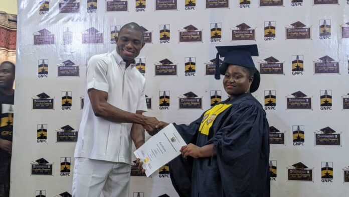 Dr. Dominic Edua, Executive Secretary of GNPC Foundation presenting certificate to one of the graduands