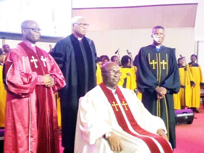 Reverend Washington Komla Darke, the Inducted Senior Minister of the Calvary Baptist Church seated and standing behind him is the Executive President of the Ghana Baptist Convention, Rev. Enock Nii Narh Thompson in red and other Senior Ministers of the Convention