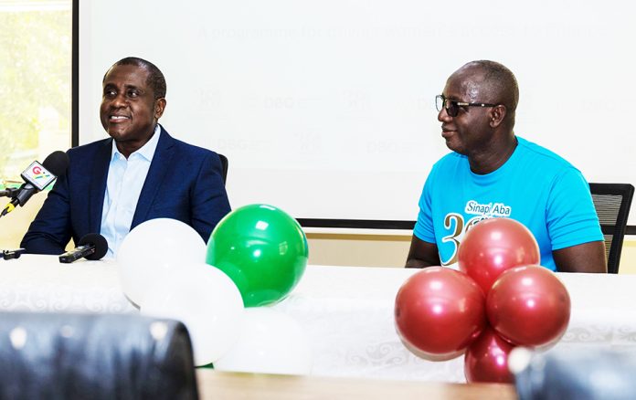 The Deputy CEO of DBG,Michael Mensah-Baah and Tony Gyasi-Fosu ,CEO, Sinapi Aba Savings and Loans ,seated at the news conference