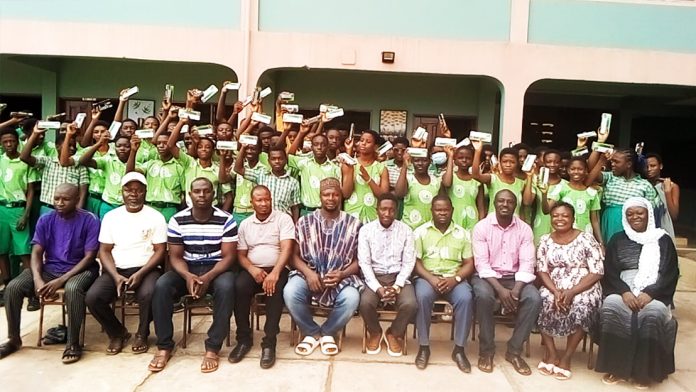 The prospective candidates with their teachers and the Assembly members in a group picture after the donation
