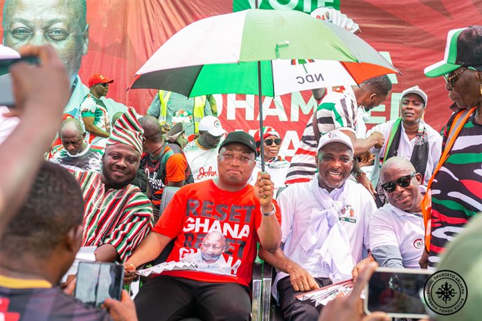 Samuel Okudzeto Ablakwa holding umbrella. On his immeidate left is NDC PC for Asawase, Muntaka Mubaraka (right)