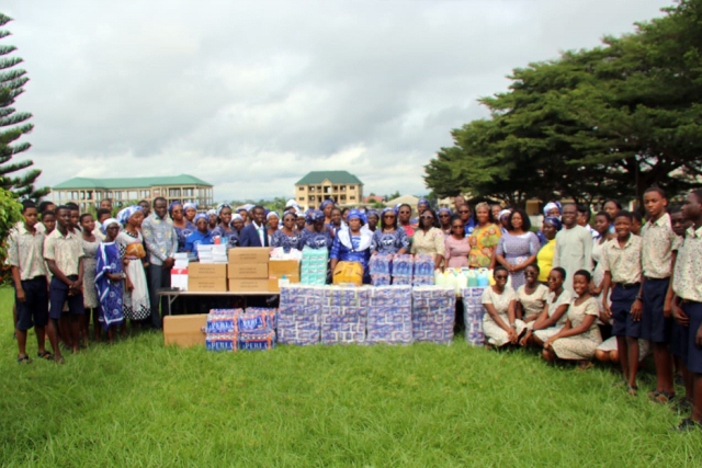 The Koforidua Area Women's Ministry and Schools Outreach Ministry of the Church of Pentecost (COP) in a group picture with the students after the donation