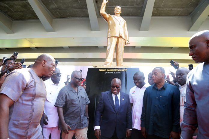 The President and his officials in front of the statue of Obetsebi-Lamptey mounted at the roundabout