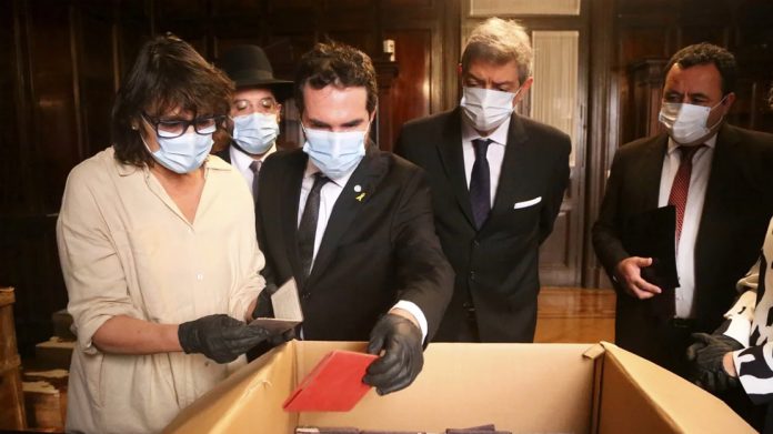 Officials inspect documents associated with the Nazi regime found by staffers in the Court's archives