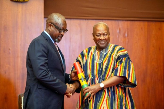 President Mahama (r) appointing COP (rtd) Nathan Kofi Boakye as a member of the Ghana Police Council