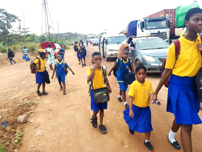 Pictures of school pupils trekking along the road