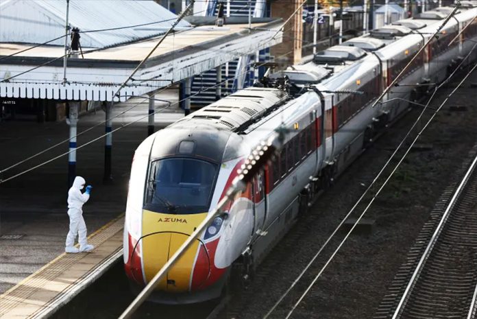 A forensic officer inspects the train where stabbings took place