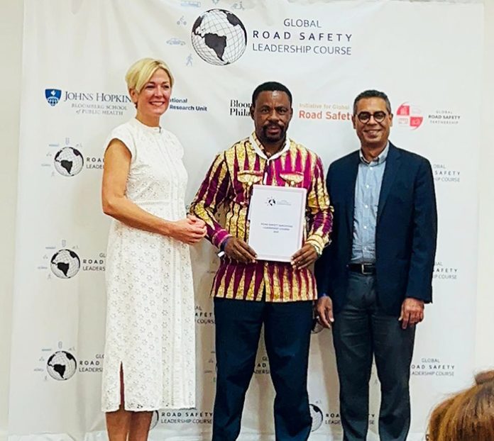 Frimpong receives a citation from Abdulgafoor M. Bachani, while David Cliff looks on admiringly