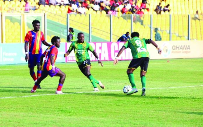 Kotoko and Hearts players fight for the ball