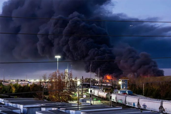 Smoke rises from the wreckage of a UPS MD-11 cargo jet