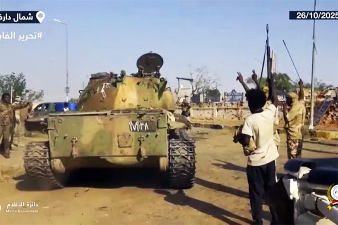 Fighters celebrating in the streets of El-Fasher in Sudan's Darfur