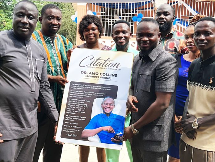 The School authorities presenting a citation to Dr. Collins Amo