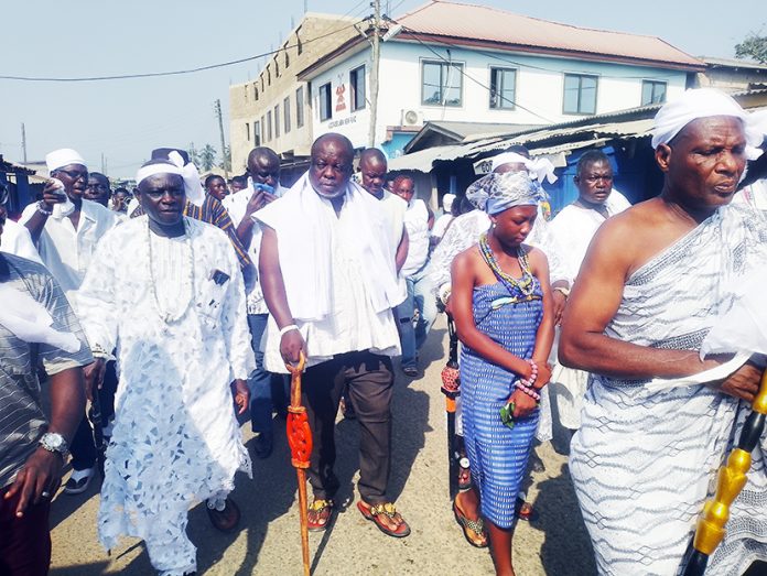 Nene Vleh II, holding his staff of authority, being outdoored on the principal streets of Big Ada