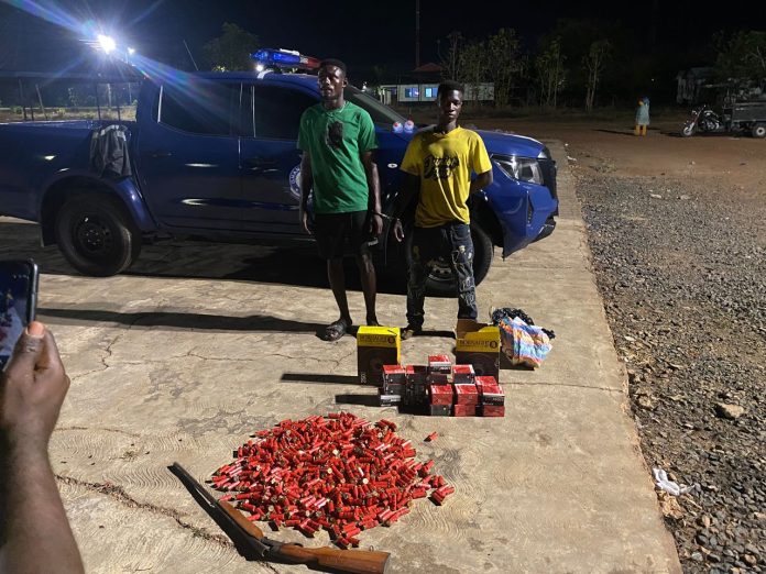 The two suspects arrested with firearms and ammunition retrieved from them.