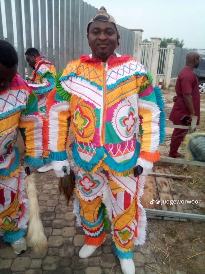 A masquerader in his elaborate costume.