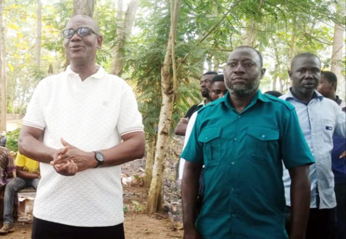 The DCE Oheneba Kobena Andoh (left) addressing the beneficiaries