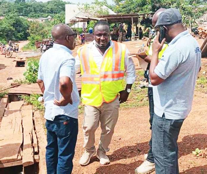 DCE Abubakar Sadik (middle) and the Road contractors at project site