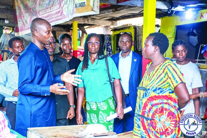 Dr Alhassan Iddrisu, head of GSS interacting with some market women