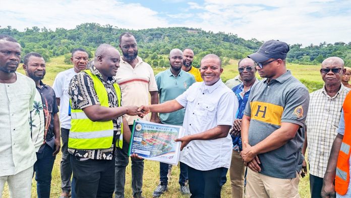 MCE Matthew Ayeh (middle) handing a document to the contractor. Nana Nteboa Pra (in cup) chief of Himan
