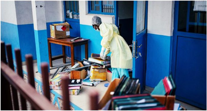 Staff members at CBCA Virunga Hospital prepare rooms intended for possible suspected Ebola cases
