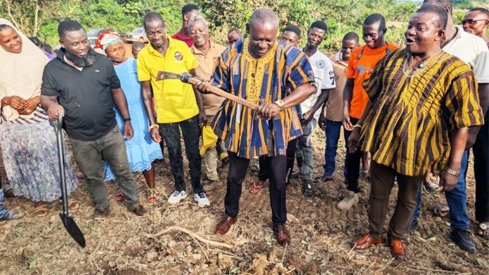 MP Robert Wisdom Cudjoe (holding the pick axe) . loking on is MCE Matthew Ayeh ( in smock)