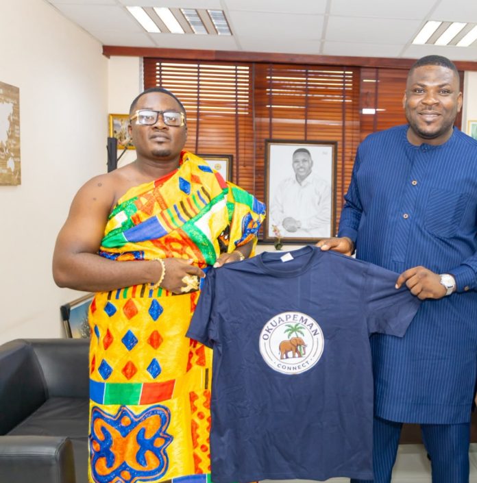 Nana Bekoe Dankwa (in kente) presenting a T shirt to the Member of Parliament (MP) for the Okere Constituency, Hon. Daniel Nana Addo Kenneth during a special engagement at Parliament.