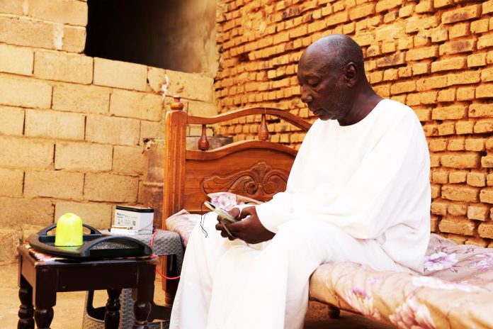 Retired Police Major General Kahil Mohamed Al-Amin, whose son was slaughtered by the Rapid Support Forces (RSF), sits on a bed during an interview, in the Salha area, south of Omdurman, Sudan, June 7, 2026.
