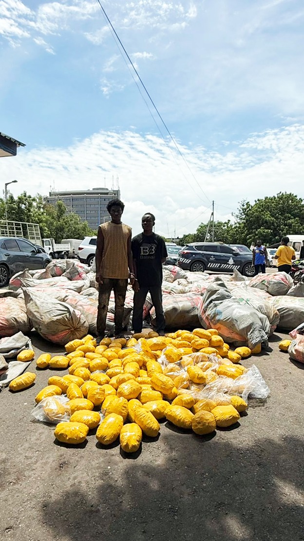 The suspects standarding in front of the suspected drugs