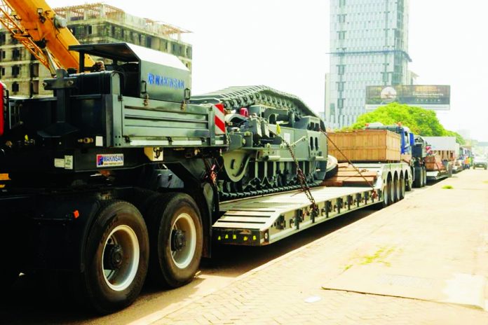 Modern mining equipment being transported to Damang