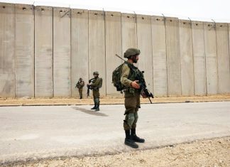 Israel is building a miles-long earthen barrier inside Gaza, entrenching its division