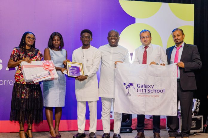 Mrs Joyce Oduro, Director of Exams, West Cluster, British Council (2nd left) presenting an award to Nana Kwaku Amoako Oduro Mensah from Galaxy International School
