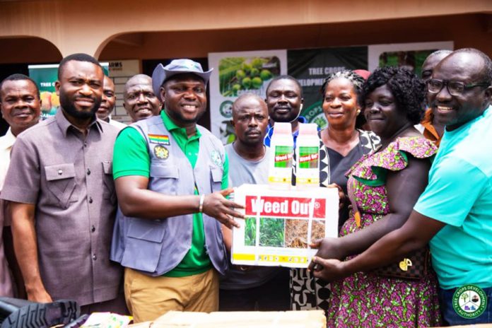 Richard Kofi Kofituo in charge of Operations, presenting the Rubber Seedlings to Beneficiary Farmers